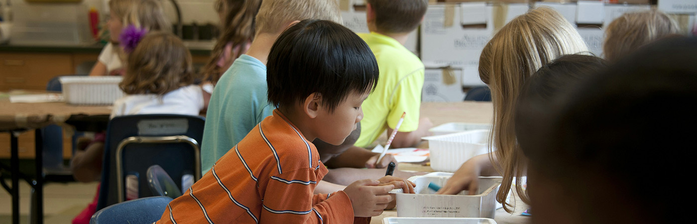 Children building printable paper models in classroom